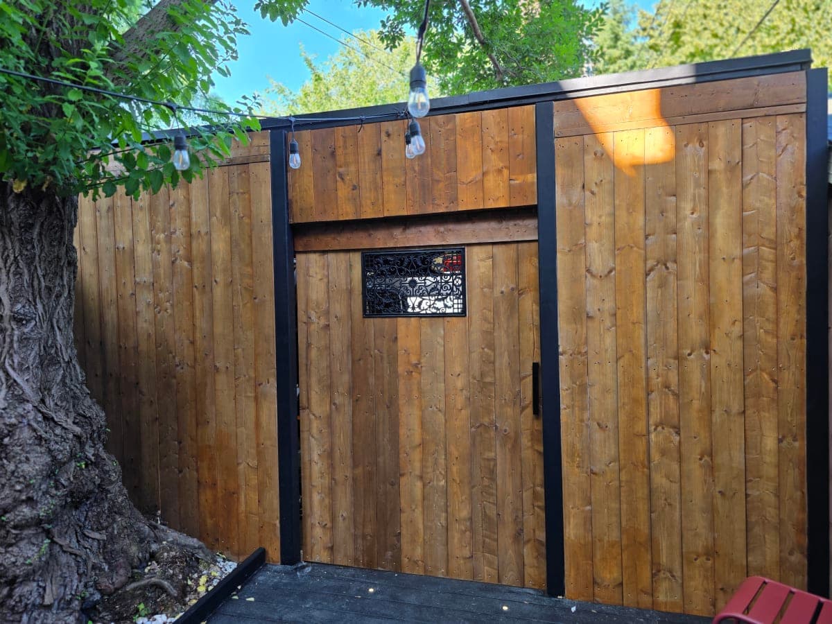 Wooden gate installed in snowy Canadian backyard