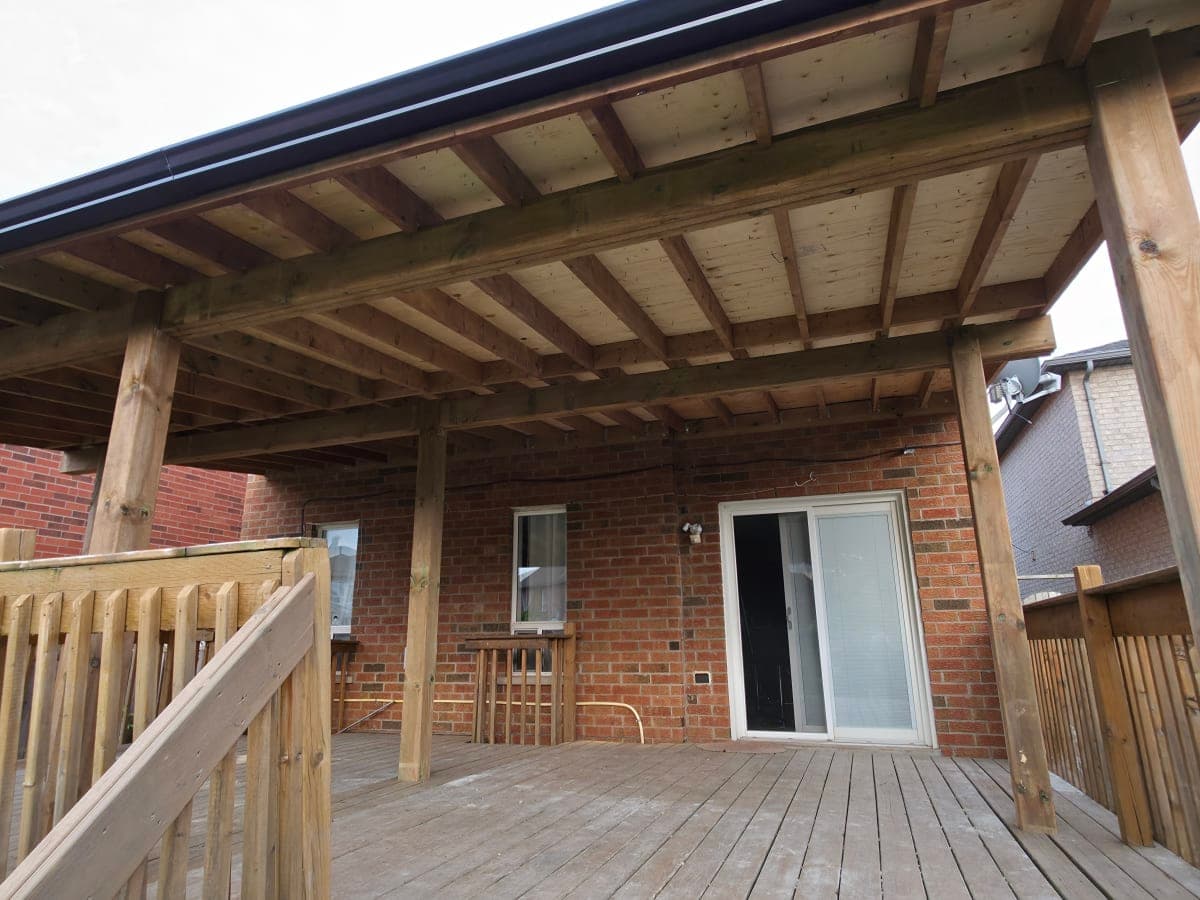Roof installation in progress under clear Canadian sky