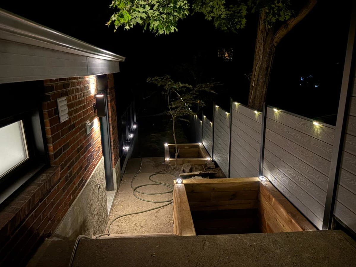 Outdoor lighting installation in a backyard during evening