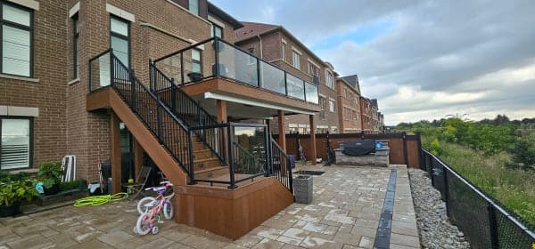 A wooden deck in a Canadian backyard with snow around