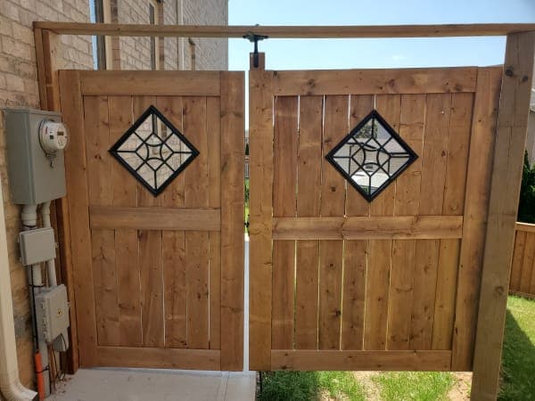 Wooden gate under construction on a rural property during spring