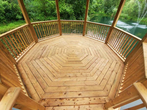 Wooden gazebo under construction in a backyard