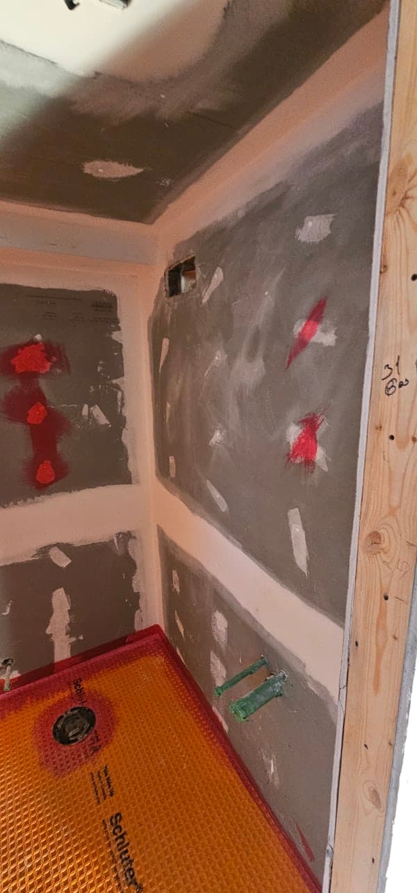 Interior home renovation work in progress with exposed framing and drywall